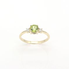 14k Peridot Diamond Ring | 5.0MM Natural Peridot Engagement Ring | 14k Peridot Wedding Ring | August Birthstone Ring | 14k Peridot Ring | Handmade Jewelry P R O D U C T 𝄪 D E T A I L S ✽ Metal: 14k Yellow Gold, White Gold & Rose Gold ✽ Bottom Band Width: 1.5 MM ✽ Stone Size: Natural Peridot 5.0 MM x 1pc (approx. 0.5ct) / Natural Diamond 2.3 MM x 2pcs (approx. 0.10ct) ✽ Diamond Color: G ✽ Diamond Clarity: VS2-SI1 ✽ Made to Order ✽ Same Design in Different Birthstone:   - Garnet: https://etsy.me/ Yellow Gold Peridot Ring, Yellow Gold Peridot Diamond Ring With Birthstone, Green Three-stone Birthstone Ring In 14k Gold, Green Three Stone Birthstone Ring In 14k Gold, Yellow Gold Peridot Diamond Ring, Yellow Gold Peridot Ring With Center Stone, Fine Jewelry Peridot Birthstone Ring In Round Cut, Fine Jewelry Peridot Birthstone Ring Round Cut, Fine Jewelry Peridot Birthstone Ring