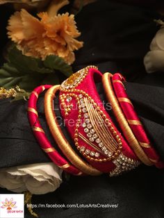 Raw silk thread red and gold matching bangles and a kangan with minimalistic peacock design and stone work. Perfect match for a lehengas or saree. Call or whatsapp +919840009398 to place your customised order. International and domestic orders accepted. https://m.facebook.com/LotusArtsCreatives/ Silk Thread Earrings, Silk Thread Bangles, Thread Bangles, Thread Earrings