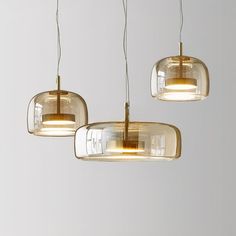 three glass pendant lights hanging from the ceiling