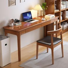 a laptop computer sitting on top of a wooden desk next to a air conditioner