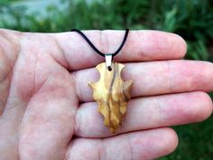 I hand-carved this one-of-a-kind arrowhead pendant from Spalted Exotic Olivewood with very unique spalting lines. It's fully carved in the round on both sides so you can hang either way. I like the look of primitive arrowheads so I emulate that style in my carvings.  A hand rub finish is applied and then the pendant is buffed to a buttery smooth final finish that feels amazing to the touch.  You can choose from a variety of necklace/cording options including: 18" or 22" stainless steel chain A v Rustic Arrowhead Necklace For Gift, Artisan Arrowhead Necklace For Gift, Brown Arrowhead Necklace For Gift, Rustic Handmade Arrowhead Necklace, Arrowhead Pendant, Natural Necklace, Minimalist Pendant, Hand Wipes, Arrowhead Necklace