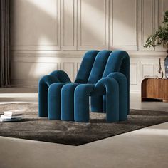 a blue chair sitting on top of a rug in a living room