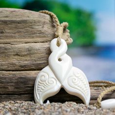 High-Quality Bone Art - Sold by Bali Necklaces. www.balinecklaces.com Hand carved on the Tropical Island of Bali. Each Bali Necklace helps to fund Coral Reef Conservation! Learn about our efforts! Just as human finger prints are unique to each person, each whale tale is unique to the individual whale. When excited, whales slap their flukes on the surface of the sea creating a powerful clap. They represent power that is only intensified by the strength of the sea. The Whale Tail represents power, individuality and grace. Pendant Materials: Repurposed, Water-Buffalo Bone Pendant size: Approximately 2 inches (5 cm). Cord: Hand-Braided, Bamboo Cotton. One size fits all. Adjustable from choker up to 26 inches. Unique Carved White Necklace, Unique White Carved Necklace, White Carved Pendant Necklaces, Traditional White Carved Necklaces, White Carved Pendant Necklace, Artisan Carved White Necklace, White Carved Amulet Necklace, Artisan White Engraved Necklace, Whale Tale