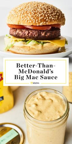 a hamburger with cheese and lettuce next to a jar of mustard