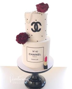 a chanel cake with lipstick and roses on top