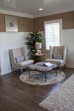 a living room with two chairs and a coffee table in the middle of the room