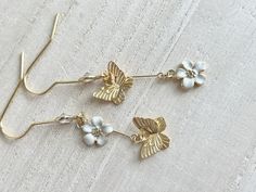 These dainty butterfly earrings with flowers are made of the followings: (1) Matt gold plated butterfly charm (Size: 8 x 10mm) (2) gold plated enamel flowers charm (size: 9 x 8mm) (3) gold plated earring hooks with cubic zirconia The total length of the earrings is about 47mm. ✏️ Please choose your desired color of flower 【BEFORE PURCHASE, PLEASE NOTE THE FOLLOWINGS】 ☆ VAT, GST and any other taxes from your country are NOT included in the listing price. Buyers are responsible for any aforesaid t Whimsical White Butterfly Jewelry, White Butterfly Charm Earrings For Wedding, Dainty Butterfly Earrings For Wedding, White Dainty Butterfly Earrings, Dainty White Butterfly Earrings, Ring Charm Necklace, Enamel Flowers, Dainty Butterfly, January Birthstone Rings