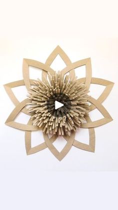 a paper flower made out of cardboard on a white background