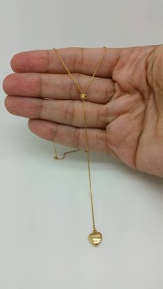 "For a limited time only, Enjoy 20% off every item in my store!! 14k Solid Yellow Gold Trendy Lariat Heart Chain Necklace (Italy) Material: 14K Solid Gold Stamped Italy Weight: Approx. 2.4 g Length- 18\" length of Pendant Lariat-from the bead to the heart-3.5 inches Please note that all of my items are 100% genuine 14k solid gold. Please be confident, none are plated or filled they are solid 14k gold. Comes in gift box! If you have any questions, please feel free to ask. I am more than happy to Heart Chain Necklace, Herringbone Necklace, Necklace Layering, Heart Chain, Layered Chains, Necklace Long, Chain Ring, Tag Necklace, Solid Yellow