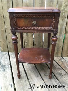 an old wooden table with a drawer on it