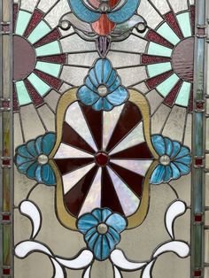 a stained glass window with flowers on it