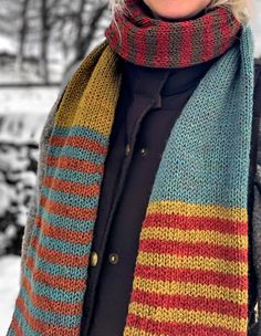 a woman wearing a multicolored scarf in the snow