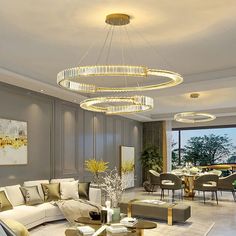 a living room filled with lots of furniture and a chandelier hanging from the ceiling