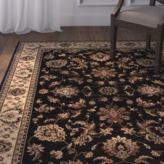 a chair and rug in front of a window