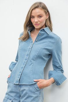 Stretched denim, hidden button down. Princess dart. /denim Trendy Denim Blouse With Button Closure, Spring Washed Blue Tops With Button Cuffs, Light Wash Denim Blouse With Button Closure, Denim Button-up Blouse With Pockets, Button-up Denim Blouse, Button-up Denim Blouse In Washed Blue, Denim Blue Button-up Blouse, Fitted Light Wash Denim Blouse, Fitted Light Wash Button-up Denim Top