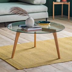 a glass table sitting on top of a wooden floor