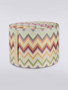 the multicolored chevron pattern on this round ottoman