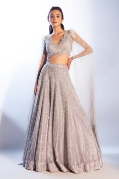 Grey attached cancan embellished lehenga. Paired with an embroidered padded blouse with floor length cape sleeves. - Aza Fashions Glamorous Designer Lehenga With Cape Sleeves, Silver Hand Embellished Floor-length Lehenga, Silver Designer Party Lehenga, Elegant Lehenga With Sequins And Cape Sleeves, Silver Hand-embellished Floor-length Lehenga, Silver Floor-length Lehenga For Party, Party Wear Lehenga With Cape Sleeves And Dupatta, Hand Embellished Lehenga With Cape Sleeves For Evening, Party Wear Lehenga With Dupatta And Cape Sleeves