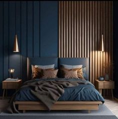 a bed with blue sheets and pillows in a dark room next to two nightstands