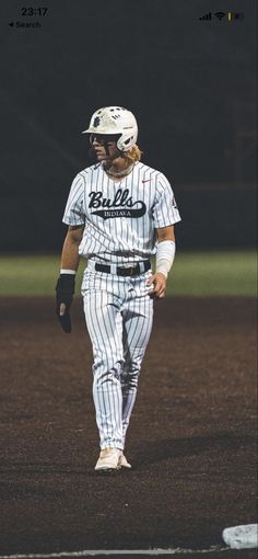 a baseball player is walking on the field