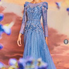 Step Into A Fairy Tale With The Exquisite Azurite Embellished Gown. This Gorgeous Gown Features Intricate Beading And Delicate Embellishments That Give It A Whimsical, Romantic Touch. The Stunning Layered Glitter Tulle Creates An Ethereal Effect That Will Make You Feel Like A Real-Life Queen. Its Belted Waistline Adds Structure To This Magical Dress, Perfect For Any Dreamy Or Enchanted Occasion. Bring Your Fairy Tale To Life In This Long Sleeve Beauty. ***Please Make Sure To Measure Yourself Bef Blue Floral Embellished Evening Dress For Gala, Blue Floral Embellished Gown For Gala, Blue Floral Embellished Evening Gown, Blue Floral Embellished Floor-length Evening Dress, Luxury Blue Gown For Banquet, Glamorous Blue Embellished Gown, Blue Hand Embellished Gown For Formal Occasions, Blue Hand Embellished Formal Gown, Formal Blue Hand Embellished Gown