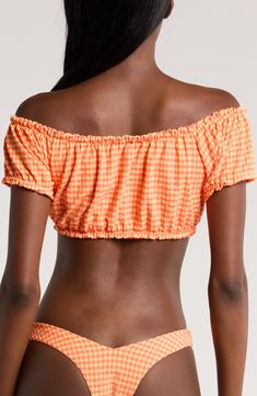 Bring on beach days in style with this frilly bandeau bikini top that drapes off the shoulders and is covered in an eye-catching pattern. Off-the-shoulder neck Short sleeves Lined 46% recycled polyester, 44% nylon, 10% elastane Hand wash, dry flat Imported Off-shoulder Tube Top For Summer Beach, Summer Off-shoulder Tube Top For Beach, Summer Bandeau Swimwear With Ruffles, Ruffled Bandeau Swimwear For Summer, Bandeau Swimwear With Ruffles For Summer, Strapless Ruffled Swimwear For Summer, Orange Strapless Tube Top For Beach, Strapless Orange Tube Top For Beach, Summer Tube Top For Poolside