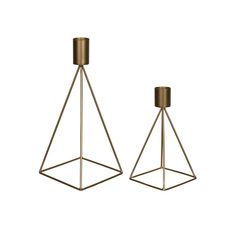 two brass metal candlesticks on white background