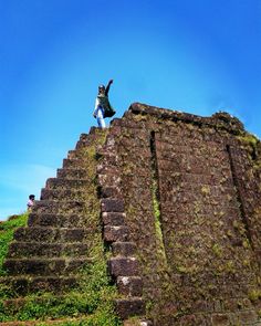 a person standing on top of a stone structure