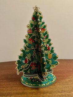 a beaded christmas tree on a wooden table