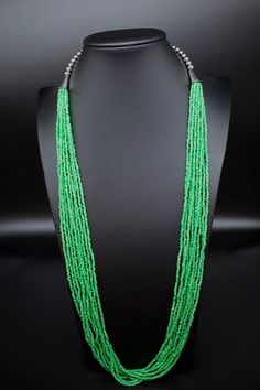 This is a multi strand green glass seed bead necklace. Southwestern glass green seed bead necklace. Dress it up or down. Great for the office.  *10 strands of glass seed beads *Adjustable length on this beauty up to 33". Has a lobster clasp. *Gift boxes available. All jewelry also comes in a nice box.  *Check out the rest of our collection: https://www.etsy.com/shop/NewMexicoGems Thank you for your business. We appreciate you. Green Multi-strand Jewelry With Tiny Beads, Green Multi-strand Beaded Jewelry, Green Beaded Multi-strand Turquoise Necklace, Traditional Green Faceted Beaded Necklaces, Traditional Green Faceted Beaded Necklace, Traditional Green Multi-strand Beads, Bohemian Beaded Emerald Necklace With Round Beads, Green Multi-strand Necklace With Tiny Beads, Traditional Green Multi-strand Beaded Necklaces