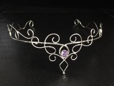 I have fabricated a sterling silver wedding circlet, or bridal tiara, which is designed to be worn for a wedding, a Renaissance event, or perhaps a hand-fasting ceremony. A beautifully handmade circlet with an elegant, Princess feel, yet still elegant to be worn and enjoyed for any high end function! This piece will go around behind the ears and is tied off, in the back, by an elastic jeweler's cord so that it will remain snug and in place while in motion. This works better than using a chain li Wedding Jewelry With Crown Design, Elegant Ceremonial Crown Headpieces, Bohemian Round Crown Headpiece For Wedding, Bohemian Wedding Headpiece With Round Crown, Elegant Ceremonial Headpiece With Pinched Crown, Ceremonial Headpiece With Tall Crown, Adjustable Tall Crown Headpiece For Ceremonial Occasions, Adjustable Ceremonial Headpiece With Pinched Crown, Traditional Round Crown Wedding Headpiece