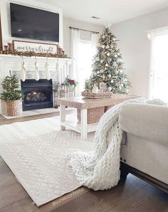 the living room is decorated for christmas with white furniture