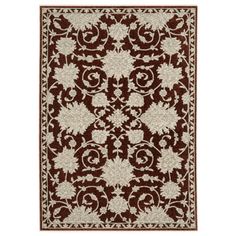 a red and white rug with an ornate design