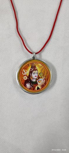 Handmade 92.5 Sterling Silver God Om Namah Shivay Shiva Religious Photo Print Glass Framed Silver Photo Unique Pendant With Colour String. Made by My Shop Members. Primary Colour Is Silver  Pendant Length With Loop 3.8 Cm. Pendant Width 3.2 Cm. Pendant Weight 4.5 gms.  Few Golden Colour Hand Work On Photo Print ,Not Total Hand Painted. Handmade Glass Framed Necklace Covered By 92.5 Sterling Silver. It's a not totally water proof, but water resistant glass framed Pendant.  Special... It's Possible to Make as Customers Choice like Couple /Be loved / Pet / Ideal/Someone special Every Type of Print. Your Feedback is very Important for us so leave positive Feedback. If you have any Problem or you are not satisfied with our product so Please Contact us before leaving negative Feedback. We also B Handmade Orange Jewelry For Puja, Nickel-free Necklaces For Festivals, Adjustable Pendant Necklace For Puja, Red Round Necklace For Puja, Religious Photos, Om Namah Shivay, Photo Pendant, Beautiful Gift Wrapping, Handcrafted Rings