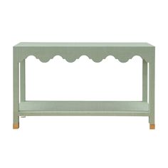 a light green console table with scalloped edges on the top and bottom, against a white background