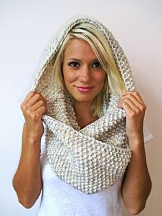 a woman is wearing a crocheted cowl around her head and posing for the camera