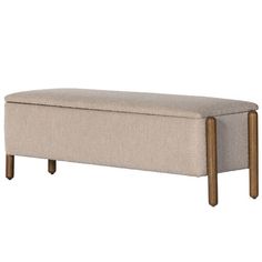 an upholstered bench with wooden legs and a light colored fabric seat cover on it