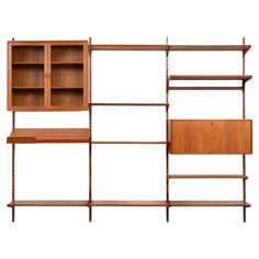 the wall unit is made out of wood and has three shelves, one with two open doors