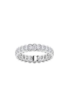 a white gold ring with three round diamonds on the inside, and two rows of small stones