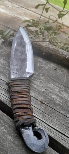 a knife that is sitting on top of a wooden table