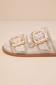 Everyone loves a slide-on sandal for the summertime, and the Schutz Enola Sporty Casual Oyster Buckled Slide Sandals are our favorite pick for this season! These trendy sandals feature an open-toe upper and wide, woven fabric straps with adjustable, chunky gold bamboo-inspired buckles for a statement-making finish. Style with a breezy, wide-leg jumpsuit to keep yourself stylishly cool! 1. 25" sole. Smooth insole. Felted rubber sole has nonskid markings. Man made materials. Imported. Lulus | Enol Summer Flat Heel Flip Flops With Buckle Closure, Poolside Slip-on Sandals With Textured Footbed, Chic Summer Footbed Sandals With Buckle Closure, Beige Round Toe Slides For Beach, Beige Round Toe Slides For The Beach, Beige Slides For Beach, Open Toe Footbed Sandals For Beach Season, Flat Sandals With Buckle Closure For Beach, Trendy Beach Sandals With Buckle Closure