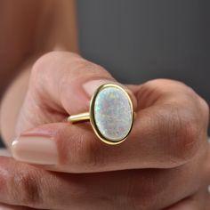 Opal Ring, Vintage Opal Ring, Minimalist Ring, Mother's Day Gift, October Birthstone Ring, Stacking Ring, Gift For Her Elevate any look with our Vintage Opal Ring. This minimalist piece exudes timeless charm, making it a perfect gift for Mother's Day or October birthdays. Crafted with care, its iridescent opal centerpiece adds a touch of elegance to any outfit. Stack it or wear it solo for understated luxury. A beautiful minimalist piece to have in ones collection 🎀 Free Returns and Money-back Gift White Opal Gemstone Ring, Gold Opal Rings As Gift, Gold Opal Rings For Gifts, Opal Birthstone Ring As A Gift, Oval Opal Rings With Bezel Setting, White Ethical Gemstone Rings For Gift, Fine Jewelry Opal Ring As A Gift, Fine Jewelry Opal Ring For Gifts, Fine Jewelry Opal Ring Gift