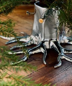 an octopus planter is sitting on the floor next to some pine needles and branches