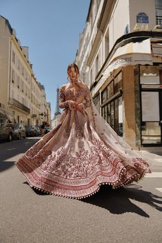 Maroon & Ivory Lehenga Set captivates with handcrafted embroidery on raw silk. The net and raw silk blouse features a unique silhouette, complementing the rich textures of the ensemble. Paired with a delicate net dupattaFrom Jigar Nikita’s 11:11 In Paris collection DELIVERY TIMEPlease allow 8-12 weeks for your outfit to arrive. FABRIC DETAILSLehenga - Raw silk, Blouse - Net and Raw Silk, Dupatta - Net Professional cleaning only. Beige Floor-length Sets With Intricate Embroidery, Semi-stitched Silk Gown With Intricate Embroidery, Bollywood Style Silk Gown With Intricate Embroidery, Bohemian Saree-style Wedding Gown, Designer Silk Gown With Intricate Embroidery, Bohemian Wedding Gown With Resham Embroidery, Beige Bollywood Gown With Intricate Embroidery, Bohemian Wedding Lehenga With Sheer Dupatta, Bollywood Beige Gown With Intricate Embroidery