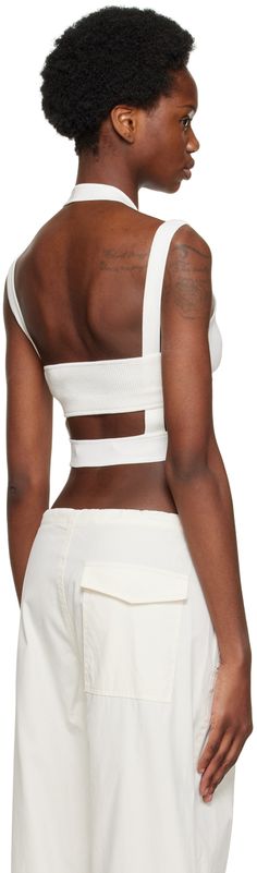 Rib knit stretch nylon-blend tank top. Cut out detailing throughout. · Layered construction · Halter strap Supplier color: Ivory Chic White Crop Top With Tank Straps, Chic White Tank Top With Straps, Chic White Tank Top With Seamless Construction, White Chic Crop Top With Seamless Construction, Chic White Seamless Tank Top, Chic White Bandage Crop Top, Chic White Crop Top With Seamless Construction, Chic White Seamless Crop Top, Chic Crop Top With Seamless Construction And Tank Straps