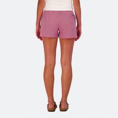 the back view of a woman in pink shorts