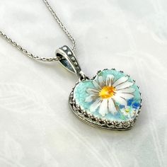 "Beautiful and elegant!   Our romantic daisy necklace is a lovely 20th anniversary gift for your wife. Vintage and repurposed china heart necklace. Sterling Silver Our adjustable 22\" sterling silver chain is included. It easily slides and you can wear it high to low. This chain makes it easy to change the length by adjusting it from the back. It always ready for any outfit and to layer with other chains. She will simply adjust the chain to the perfect length. China heart charm measures  .75\" X .75\". Have questions or want more photos? I'll be happy to provide them. DinnerWear Jewelry® ~ Specializing in one of a kind pieces since 1998. Our individually hand crafted pieces are 100% guaranteed. SHIPPING : Free shipping to USA for jewelry. We ship worldwide from the USA. Expedited shipping Silver Birth Flower Necklace For Anniversary Gift, Silver Birth Flower Necklace For Anniversary, Sterling Silver Birth Flower Jewelry For Anniversary, Elegant Daisy-shaped Gift Jewelry, Silver Daisy Jewelry Gift, Silver Daisy Jewelry For Gift, White Daisy Shaped Necklace For Gift, Nickel Free Flower Shaped Necklace For Anniversary, Nickel-free Flower Shaped Necklaces For Anniversary