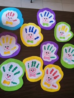 paper plates with hand prints on them sitting on a table