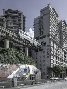 an elevated train passing over a city street