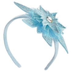 a blue headband with flowers and crystals on it's side, against a white background